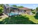 Spacious backyard with screened-in pool, lush lawn, and landscaping, offering a private outdoor oasis at 10116 Pointview Ct, Orlando, FL 32836