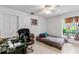 Simple bedroom with tile floor, ceiling fan, and a window that brings in natural light, ideal for relaxation at 10116 Pointview Ct, Orlando, FL 32836