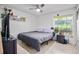 Comfortable bedroom with neutral tones, tile flooring, and a window overlooking the backyard at 10116 Pointview Ct, Orlando, FL 32836