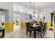 Bright dining room with tile floors, a wooden table, and access to other rooms, perfect for Gathering gatherings at 10116 Pointview Ct, Orlando, FL 32836