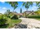 Charming single-story home with a well-manicured lawn, mature landscaping, and a welcoming circular driveway at 10116 Pointview Ct, Orlando, FL 32836