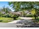 Beautiful home with mature landscaping, palm trees, and a circular driveway at 10116 Pointview Ct, Orlando, FL 32836