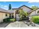 Attractive home featuring a double-door entry, arched transom window, and manicured shrubs at 10116 Pointview Ct, Orlando, FL 32836