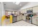 Well-lit kitchen with stainless steel appliances, tile flooring, and ample counter space, perfect for cooking at 10116 Pointview Ct, Orlando, FL 32836