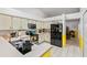 Functional kitchen with tile floors, white cabinetry, and modern appliances, seamlessly connecting to the dining area at 10116 Pointview Ct, Orlando, FL 32836