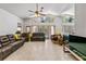 Spacious living room with high ceilings, tile flooring, and large windows that let in plenty of natural light at 10116 Pointview Ct, Orlando, FL 32836