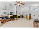 Bright living room with tile floors, ceiling fan, and fireplace, offering a cozy yet spacious atmosphere at 10116 Pointview Ct, Orlando, FL 32836