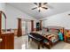 Spacious main bedroom with tiled floors, french doors, and comfortable furnishings at 10116 Pointview Ct, Orlando, FL 32836