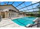 Relaxing screened-in pool area with large pool and white patio at 10116 Pointview Ct, Orlando, FL 32836