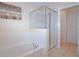 Relaxing bathroom featuring a garden tub and a glass-enclosed shower at 1040 Andalusia Loop, Davenport, FL 33837