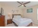 Comfortable bedroom with ceiling fan, bedside tables and lamps at 1040 Andalusia Loop, Davenport, FL 33837