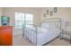 The bedroom features a large window, stylish lamps and metal bedframe at 1040 Andalusia Loop, Davenport, FL 33837