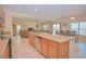 Spacious kitchen featuring granite countertops and an open floor plan with views of the living and dining areas at 1040 Andalusia Loop, Davenport, FL 33837