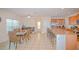 Open concept kitchen and dining area featuring granite countertops, tile floors, and stainless appliances at 1040 Andalusia Loop, Davenport, FL 33837