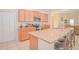 Stylish kitchen featuring granite counters, stainless appliances, and bar seating for casual dining at 1040 Andalusia Loop, Davenport, FL 33837