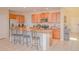 Well-lit kitchen with stainless steel appliances, granite countertops, and an open breakfast bar at 1040 Andalusia Loop, Davenport, FL 33837