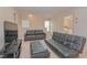 Cozy living area with a comfortable seating arrangement and plenty of natural light at 1040 Andalusia Loop, Davenport, FL 33837