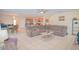 Spacious living room featuring tile flooring, modern decor, and an open concept layout at 1040 Andalusia Loop, Davenport, FL 33837