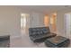 Inviting living room featuring a stylish black futon and neutral decor at 1040 Andalusia Loop, Davenport, FL 33837