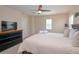 Bright main bedroom with a ceiling fan and a large bed, with nice furnishings at 1040 Andalusia Loop, Davenport, FL 33837