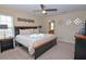 Comfortable main bedroom with large bed, ceiling fan, and decorative wall art at 1040 Andalusia Loop, Davenport, FL 33837