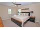Bright main bedroom with a ceiling fan and plenty of natural light through large windows at 1040 Andalusia Loop, Davenport, FL 33837