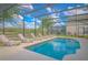 Outdoor pool with chairs and view of trees in background at 1040 Andalusia Loop, Davenport, FL 33837