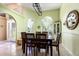 Light-filled dining room with arched windows, tile floors, and classic decor that create an inviting atmosphere at 11139 Crooked River Ct, Clermont, FL 34711