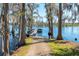 Picturesque view of a private dock on a tranquil lake surrounded by cypress trees at 11139 Crooked River Ct, Clermont, FL 34711
