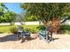 Outdoor fire pit area with Adirondack chairs surrounded by a lush green lawn at 11139 Crooked River Ct, Clermont, FL 34711