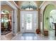 Bright foyer features a decorative glass front door, tile flooring, and views into the adjacent rooms at 11139 Crooked River Ct, Clermont, FL 34711