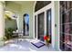 Inviting front porch featuring tile flooring, a seating area, and a decorative front door with sidelights at 11139 Crooked River Ct, Clermont, FL 34711