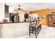 Open concept kitchen with granite countertops, stylish bar stools, and modern appliances at 11139 Crooked River Ct, Clermont, FL 34711