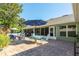 Brick patio with outdoor seating, blue umbrella, and access to a screened-in lanai at 11139 Crooked River Ct, Clermont, FL 34711
