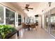 Covered patio with tile flooring, ceiling fans, and wicker furniture for outdoor entertaining at 11139 Crooked River Ct, Clermont, FL 34711