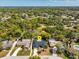 An aerial view showing the property, pool, neighborhood, and lush green landscaping at 116 E Cottesmore Cir, Longwood, FL 32779