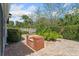 Outdoor brick barbecue area with lush landscaping and privacy fence at 116 E Cottesmore Cir, Longwood, FL 32779