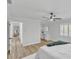 Bright bedroom featuring wood floors, a ceiling fan, and adjacent vanity at 116 E Cottesmore Cir, Longwood, FL 32779