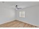 Bedroom featuring wood floors, a ceiling fan, and natural light from a large window at 116 E Cottesmore Cir, Longwood, FL 32779
