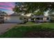 Charming single-story home with a well-manicured lawn and mature trees at 116 E Cottesmore Cir, Longwood, FL 32779