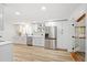 Spacious kitchen features stainless steel appliances, white cabinets, bright light, and modern finishes at 116 E Cottesmore Cir, Longwood, FL 32779
