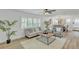 Open living area with hardwood floors, neutral furniture, plantation shutters, and modern decor at 116 E Cottesmore Cir, Longwood, FL 32779