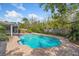 Backyard pool featuring beautiful landscaping and privacy fence at 116 E Cottesmore Cir, Longwood, FL 32779