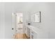 Bright dressing area featuring wood floors, quartz counters, and custom vanity at 116 E Cottesmore Cir, Longwood, FL 32779