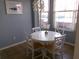 Breakfast nook with white table and chairs, large bright windows and contemporary pendant light at 1285 S South Beach Circle Cir, Kissimmee, FL 34746