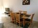 Dining room with a table, six chairs, and a mounted television at 1285 S South Beach Circle Cir, Kissimmee, FL 34746