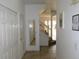 Hallway view featuring staircase with white railing and tile flooring leading to the upper level at 1285 S South Beach Circle Cir, Kissimmee, FL 34746