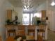 Bright kitchen featuring wood cabinets, sleek countertops, bar seating and modern pendant lighting at 1285 S South Beach Circle Cir, Kissimmee, FL 34746