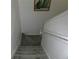 Carpeted staircase featuring gray carpet, white railings, and white walls at 1285 S South Beach Circle Cir, Kissimmee, FL 34746