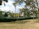 Community tennis court surrounded by fencing, mature trees, and well-kept grounds at 1285 S South Beach Circle Cir, Kissimmee, FL 34746